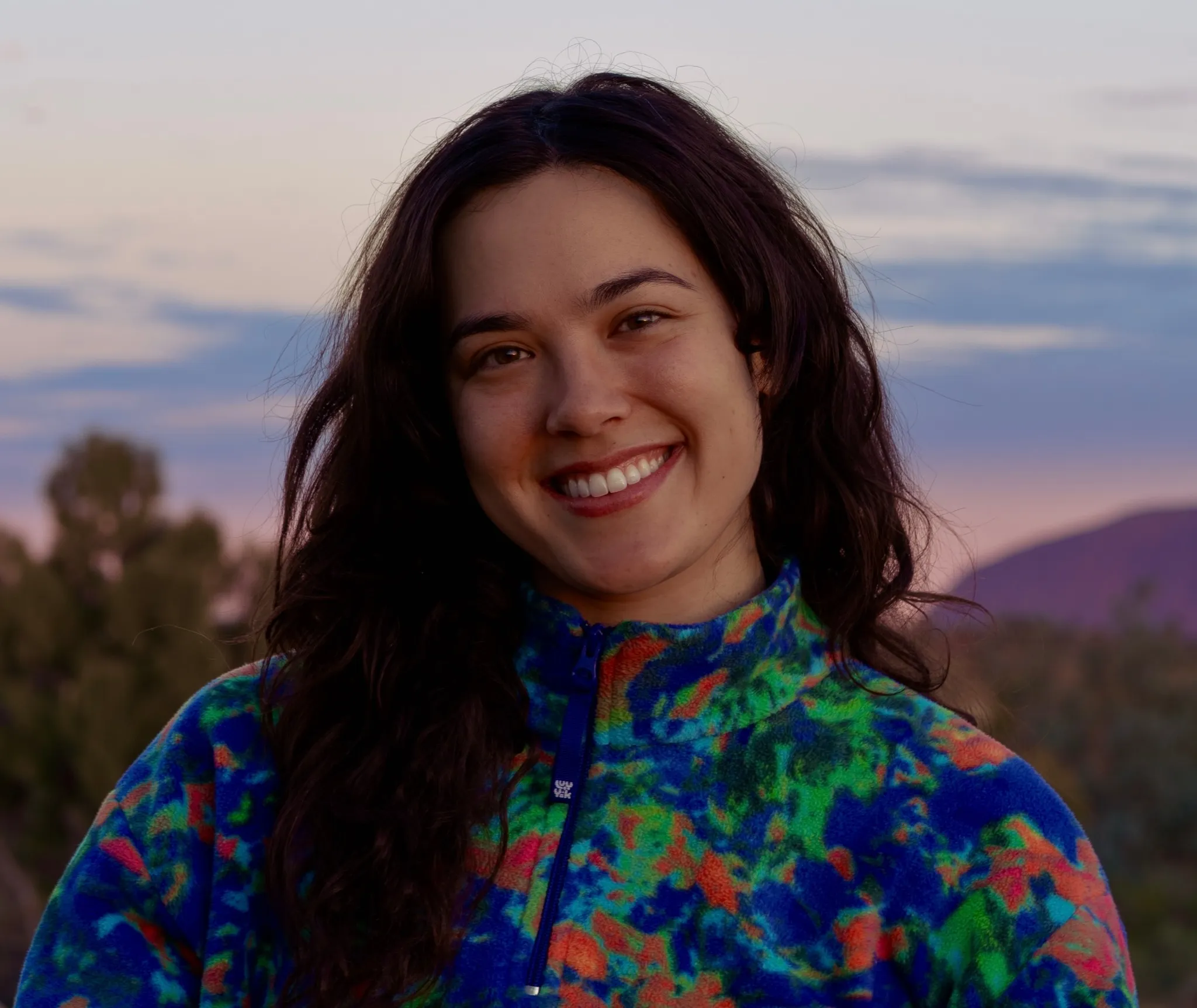 Sabrina Marcelo smiling outdoors at dusk